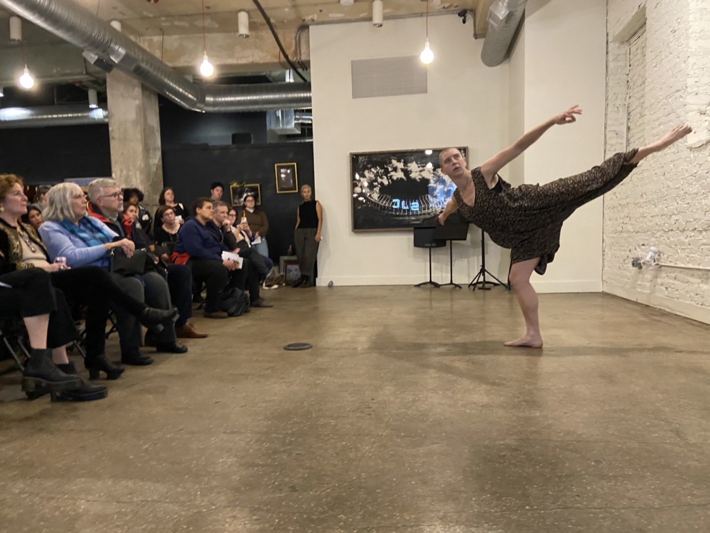 Leo Briggs dancing in front of an audience, balancing on one foot